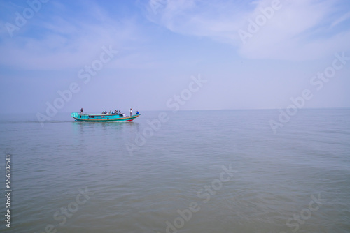 Traditional Travel Boat aginest blue sky in Padma river - Bangladesh © Artyponds