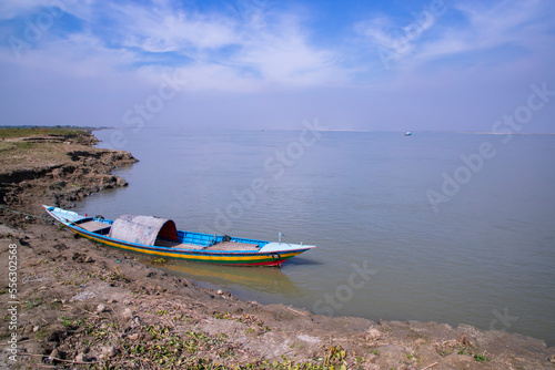 Landscape View of a boat on the bank of the Padma river in Bangladesh