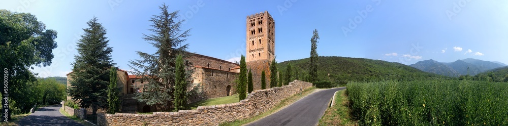 The romanesque monastery of St Michel de Cuxa with its bell tower and Pic du Canigou mountain near Prades, Pyrénées-Orientales in France