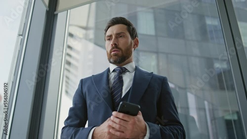 Businessman worried phone call standing office window close up. Man dissatisfied