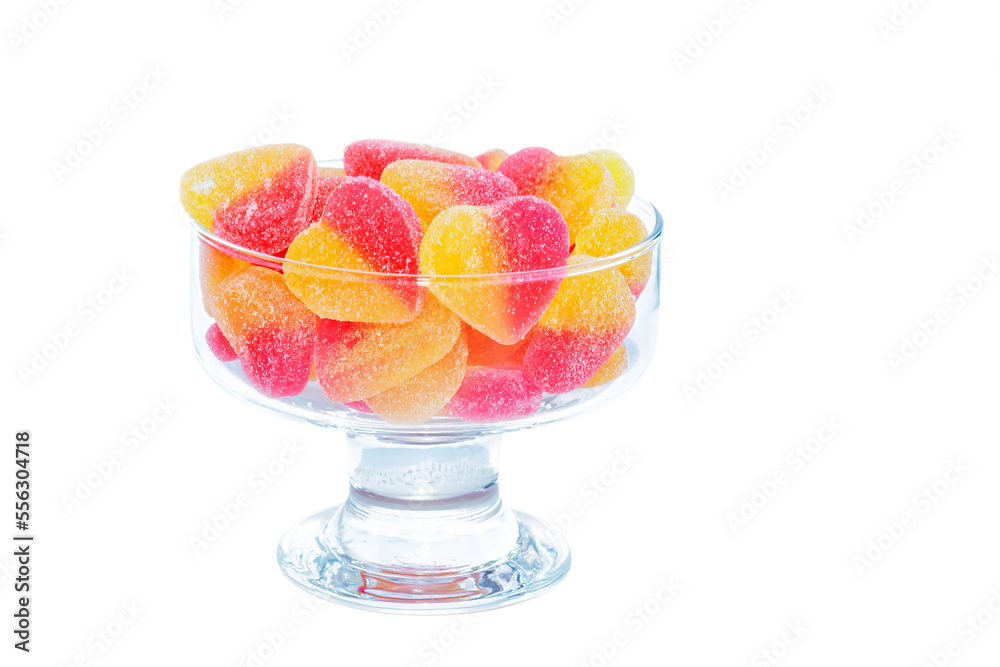 In a glass vase, multi-colored delicious jelly marmalade, isolated on a white background. In a glass vase, multi-colored delicious jelly marmalade, isolated on a white background.