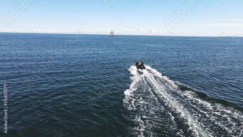 Dinghy driving to a tall ship photo