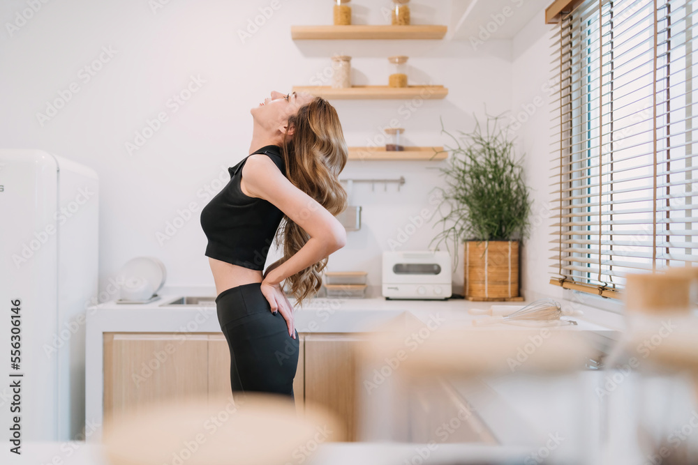 gorgeous woman bending back facing up to improve muscle control. pretty woman warming up back muscle tension for exercise. beautiful fitness woman looking up putting hands behind for stretching body