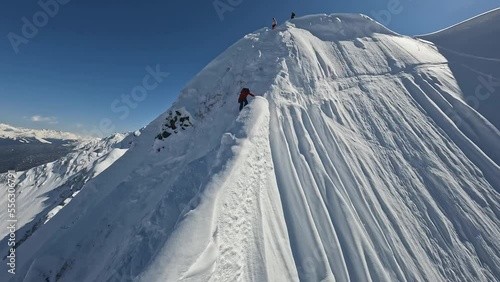 Professional snowboarding rider freeride mountain ridge snowy splash slope extreme sport leisure activity aerial view. Man red jacket riding snowboard jumping maneuver cliff peak freestyle vacation 4k