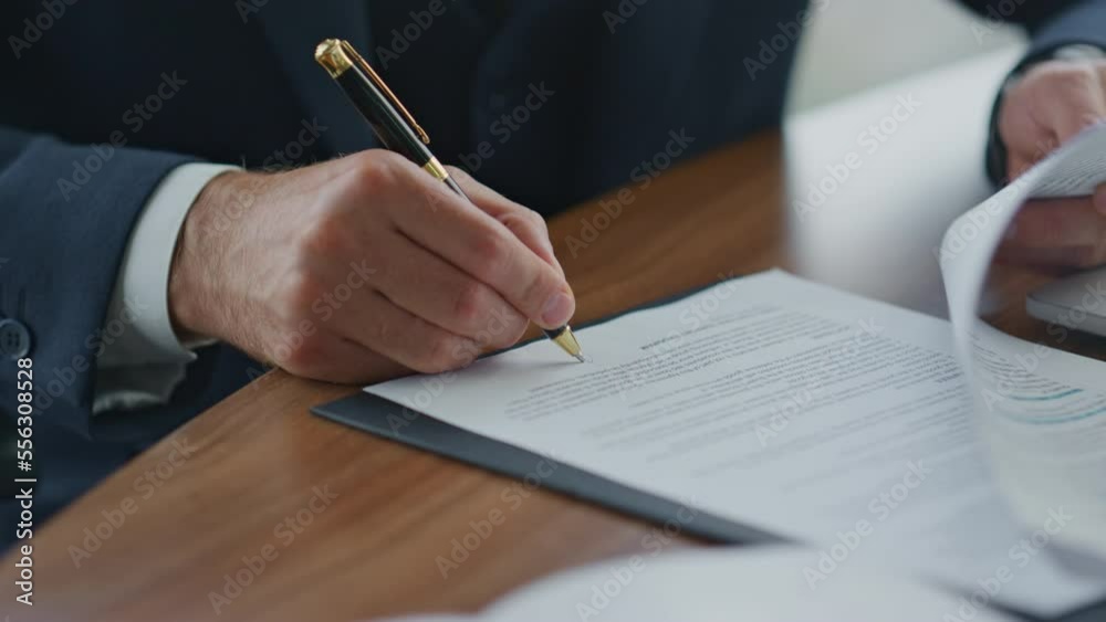 Businessman signing official documents close up. Man putting signature on papers