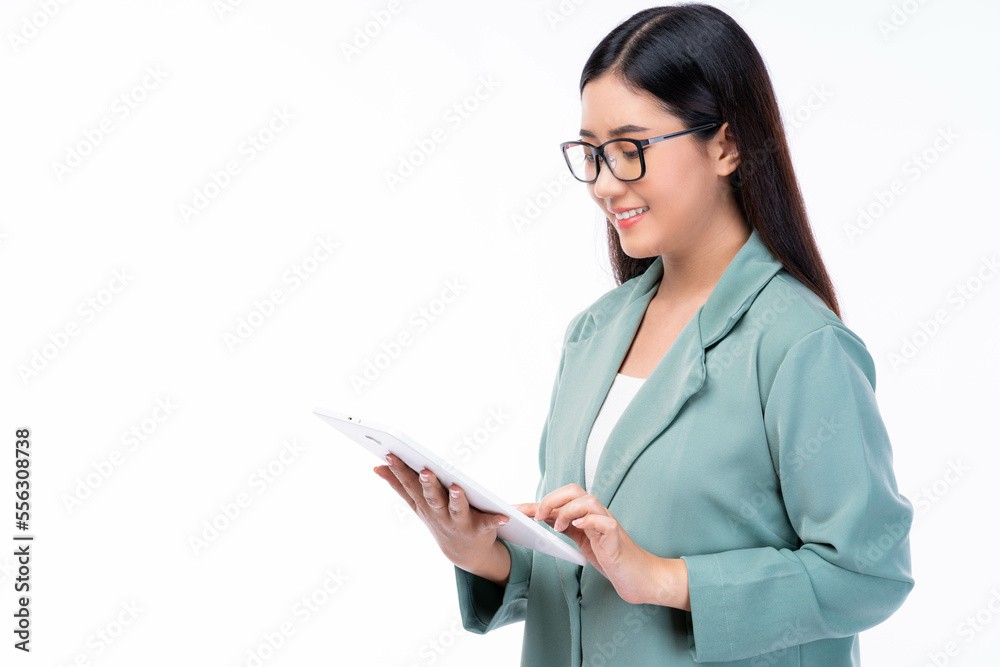 Young asian business woman company worker wear glasses Happy smiling female holding digital tablet .Beautiful lady standing over white background .Businesswomen wear green suit She working on tablet Young asian business woman company worker wear glasses Happy smiling female holding digital tablet .Beautiful lady standing over white background .Businesswomen wear green suit She working on tablet