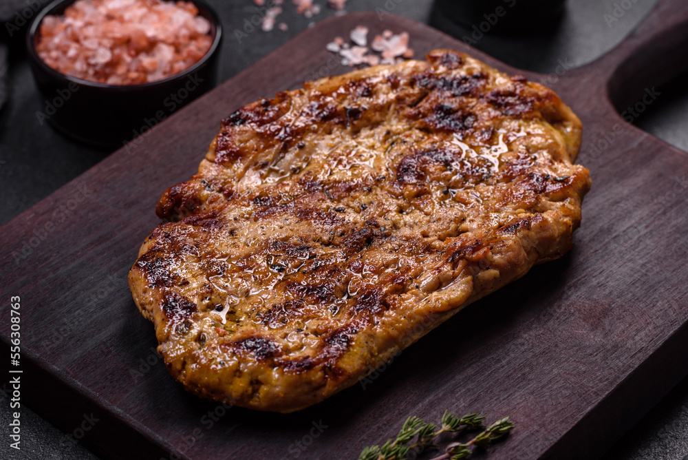 Delicious juicy grilled pork steak with spices and herbs Delicious juicy grilled pork steak with spices and herbs