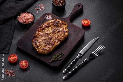 Delicious juicy grilled pork steak with spices and herbs