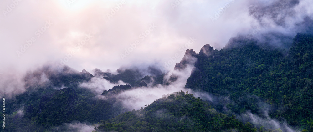 Panoramic of Beautiful landscape in morning. limestone mountains covered by mist in Vang vieng, Laos.