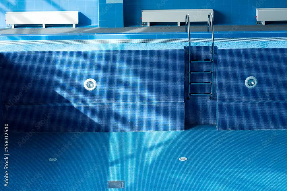 Large blue pool without water. Empty pool. Descent to a large swimming