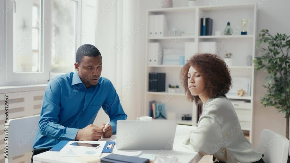 African American colleagues discussing company goals, teamwork effectiveness African American colleagues discussing company goals, teamwork effectiveness