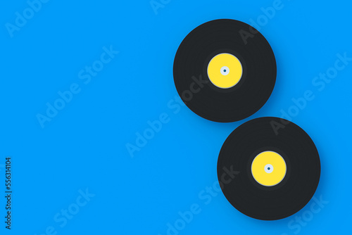 Two vinyl records on blue background. Vintage music. Old audio equipment. Top view. Copy space. 3d render