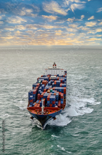 Nice aerial view of a giant container ship sailing at dawn in the English Channel photo