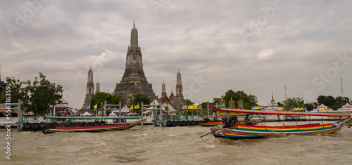 View of Wat Arun Temple from the boat tour. Wat Arun is a Buddhist temple in the Yai district of Bangkok. It is one of the most popular tourist spots in Bangkok © daphnusia