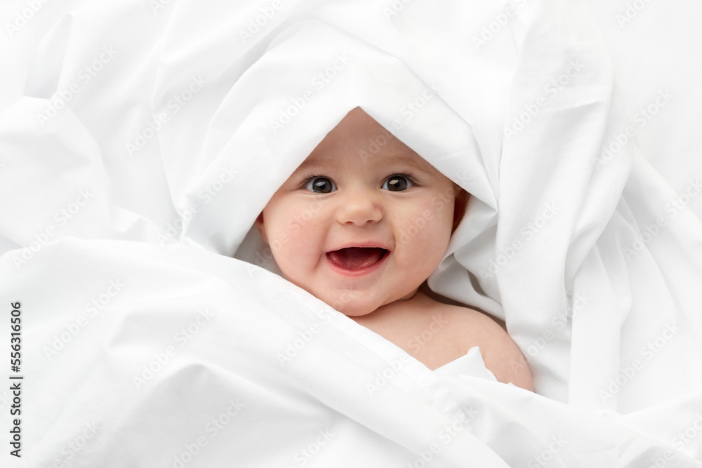 © Lisa Tichané - Smiling baby face wrapped in white sheet © Lisa Tichané - Smiling baby face wrapped in white sheet