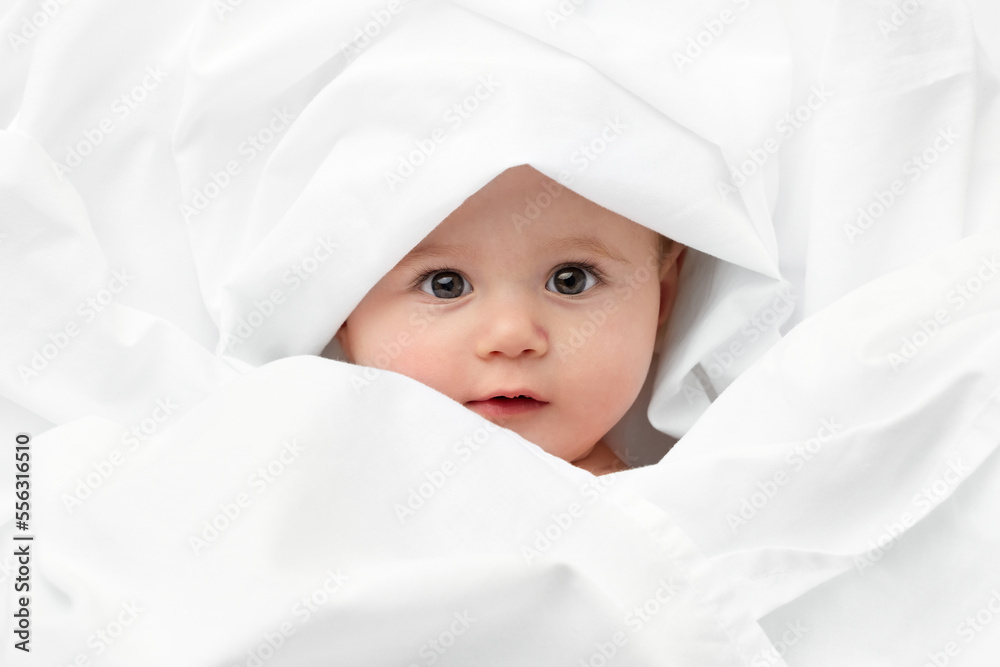 Baby face wrapped in white sheet