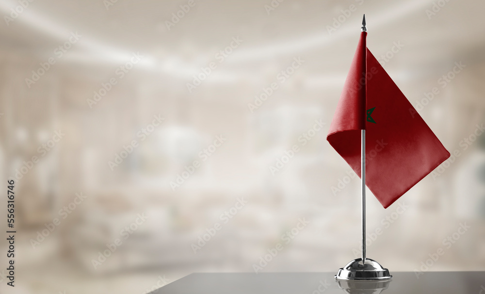 A small Morocco flag on an abstract blurry background
