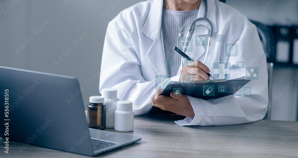 Medicine doctor touching on digital tablet and hologram modern virtual screen interface icons, Medical technology and futuristic concept. Medicine doctor touching on digital tablet and hologram modern virtual screen interface icons, Medical technology and futuristic concept.