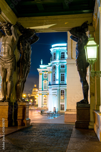 Evening view of the black sculptures of Atlanteans at the entrance to the Hermitage in St. Petersburg photo