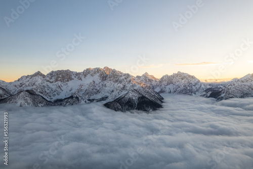 winter mountain landscape with fog at sunset 