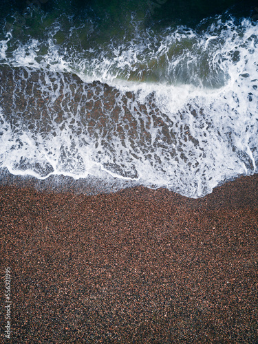 Coast with waves as a background from top view. Blue water background from drone. Summer seascape. Travel vacation concept