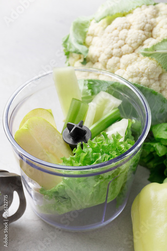 blender with fruits and vegetables on background

 photo