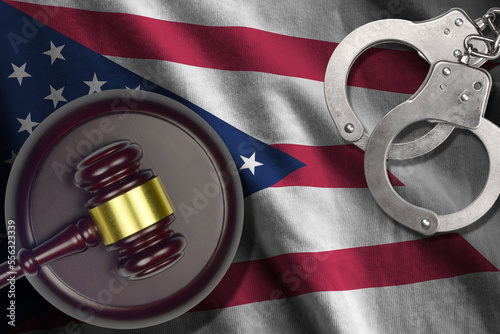 Ohio US state flag with judge mallet and handcuffs in dark room. Concept of criminal and punishment, background for guilty topics photo