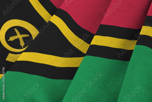 Vanuatu flag with big folds waving close up under the studio light indoors. The official symbols and colors in fabric banner photo