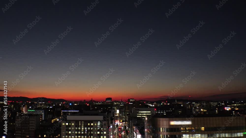 HAKATA, FUKUOKA, JAPAN - NOVEMBER 2022 : Aerial high angle time lapse shot of Fukuoka city in sunset. View of Tenjin and Nakasu downtown area from Hakata station. HAKATA, FUKUOKA, JAPAN - NOVEMBER 2022 : Aerial high angle time lapse shot of Fukuoka city in sunset. View of Tenjin and Nakasu downtown area from Hakata station.