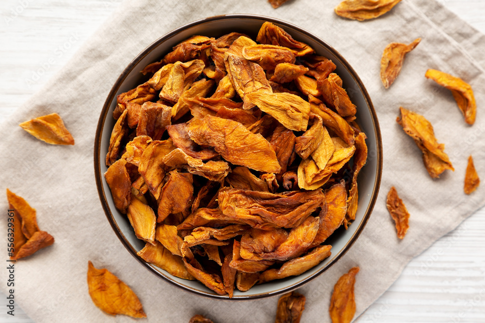 Delicious Organic Dried Mango Fruit in a Bowl, top view. Flat lay, overhead, from above. Delicious Organic Dried Mango Fruit in a Bowl, top view. Flat lay, overhead, from above.