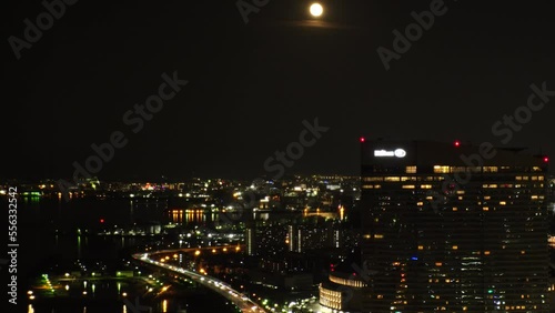 Wallpaper Mural FUKUOKA, JAPAN - NOV 2022 : Aerial high angle view of Fukuoka City and full moon. Time lapse shot at night. View around Tenjin and Nakasu downtown area. Travel and urban city nightlife concept video. Torontodigital.ca