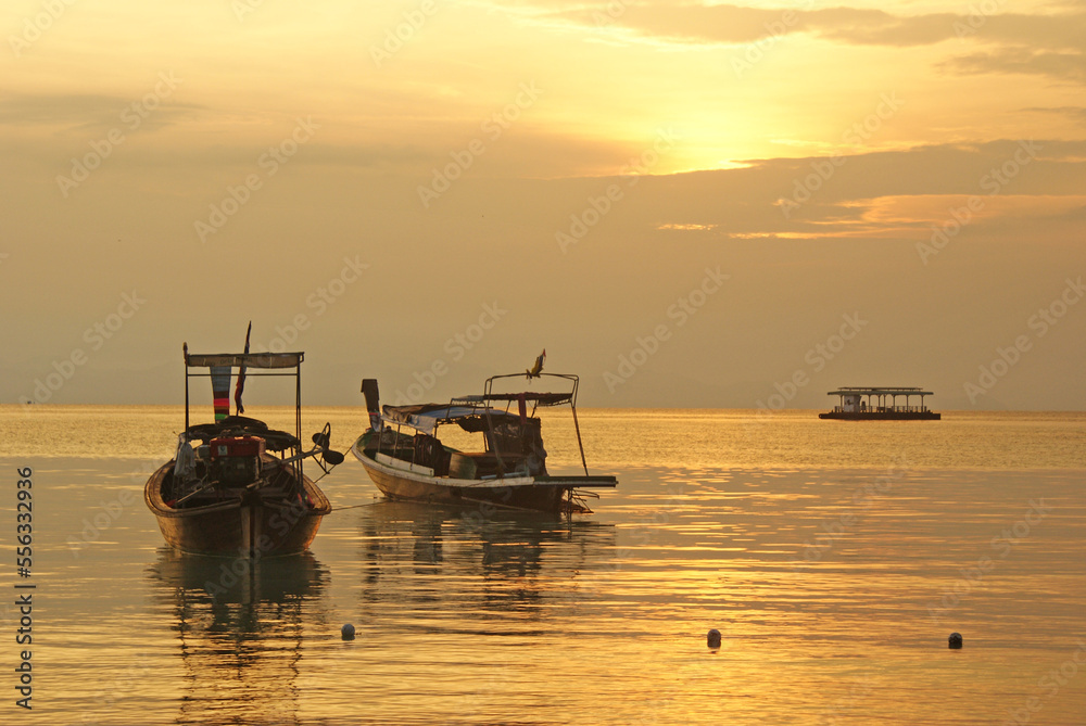 Sunset in Ko Lipe Island in (Thailand), warm orange sunlight and boats