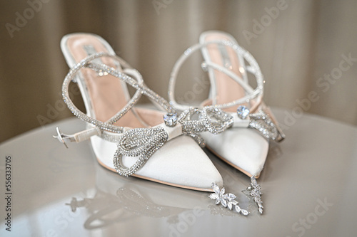 White wedding shoes with accessories.Beauty of bridal heel for marriage. Female couple boots for celebration