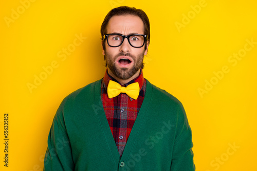 Photo portrait of young attractive male specs open mouth astonished frightened wear trendy green look isolated on yellow color background
