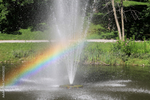 Colorful raibow above the fountain in the park