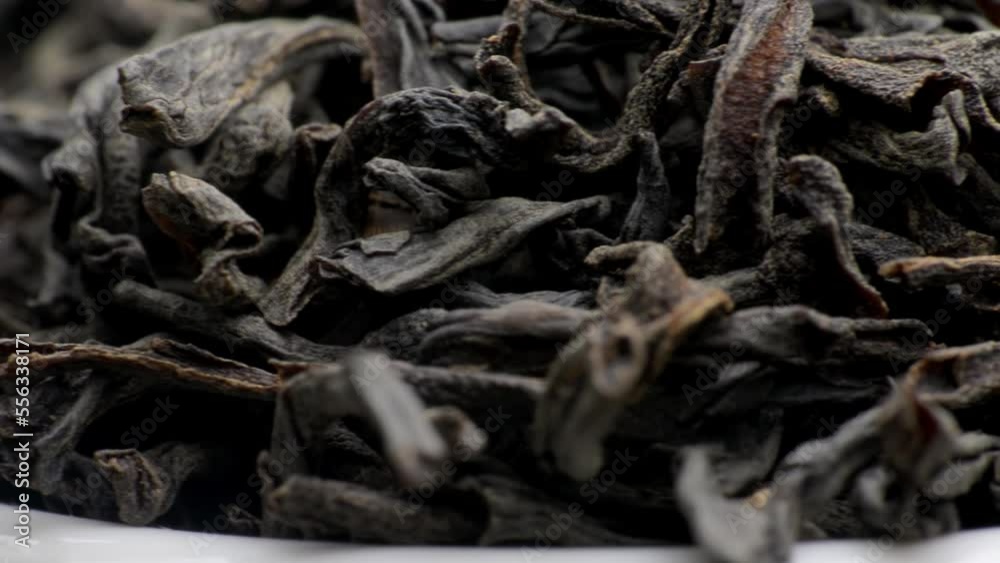 Dried black tea leaves close up. macro photography. Slow motion close-up Dried black tea leaves close up. macro photography. Slow motion close-up