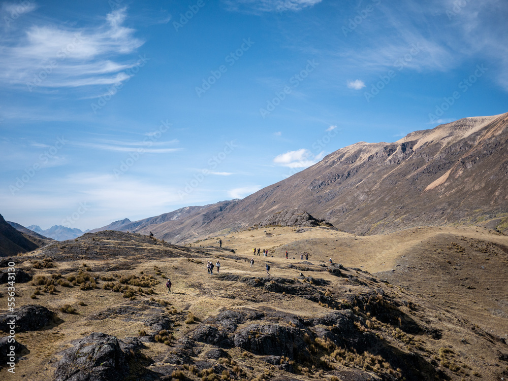 tourists walking towards the glacier on a mountain, in peru south america tourists walking towards the glacier on a mountain, in peru south america