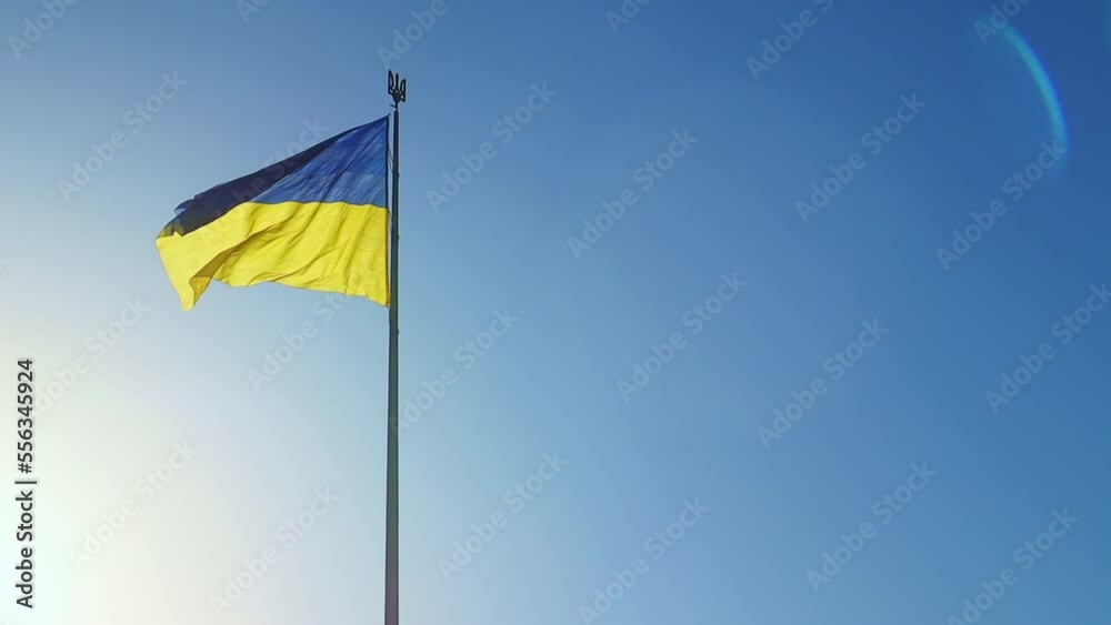 Slow motion flag of Ukraine waving in the wind against a sky without clouds at dawn of the day. Ukrainian national symbol of the country is blue and yellow. Flag loop with detailed fabric texture. Slow motion flag of Ukraine waving in the wind against a sky without clouds at dawn of the day. Ukrainian national symbol of the country is blue and yellow. Flag loop with detailed fabric texture.