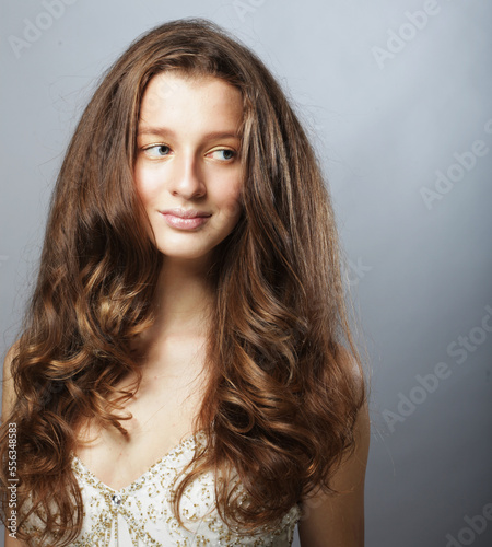 Beautiful model female with long wavy and shiny hair .