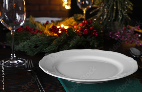 Plate  cutlery  glass and festive decor on wooden table