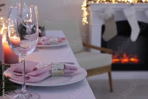 Beautiful festive place setting with Christmas decor on table indoors  space for text