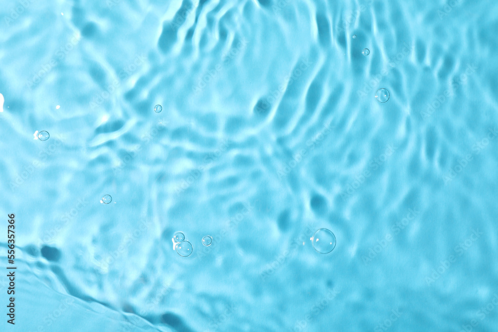 Closeup view of water with rippled surface on light blue background Closeup view of water with rippled surface on light blue background