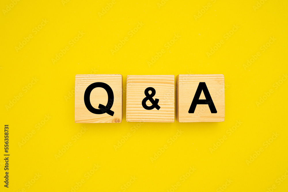 Wooden cubes with words Q and A on a yellow background Wooden cubes with words Q and A on a yellow background