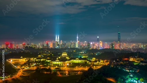 4K Time lapse of National Palace, Monarch of Malaysia overlooking the four skyscrapper tower during midnight photo