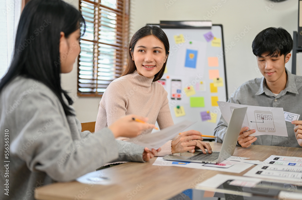 Obraz premium Attractive Asian female designer discussing with her colleague in the meeting. UI UX design concept