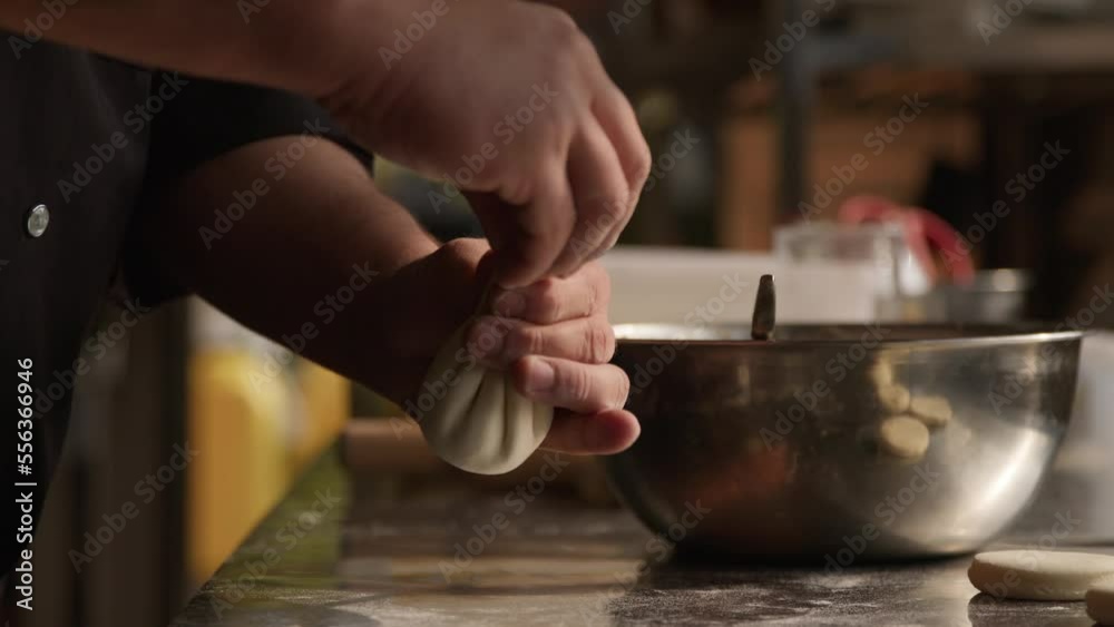 Chef making manti dumplings in a restaurant kitchen, handheld shot Chef making manti dumplings in a restaurant kitchen, handheld shot