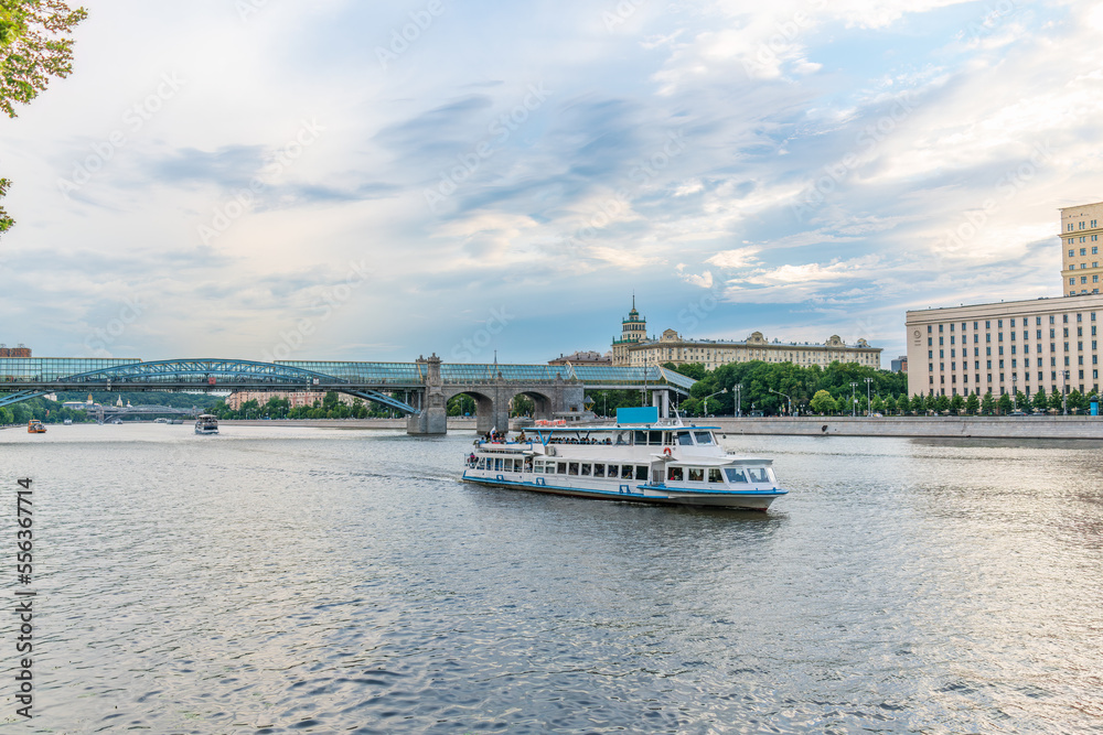 View of the Moscow river embakment, Pushkinsky bridge and cruise ships at sunset.