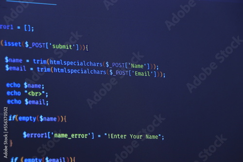 Photography Programmer coding python, java script, html code on notebook screen at home