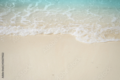 Sand beach seashore with blue wave and white foamy from blue sea in summer. © PBXStudio
