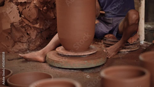 The process of forming or making pottery from clay in the form of flower pots, jugs, piggy banks, and others, located in Kasongan, Bantul, Indonesia. photo